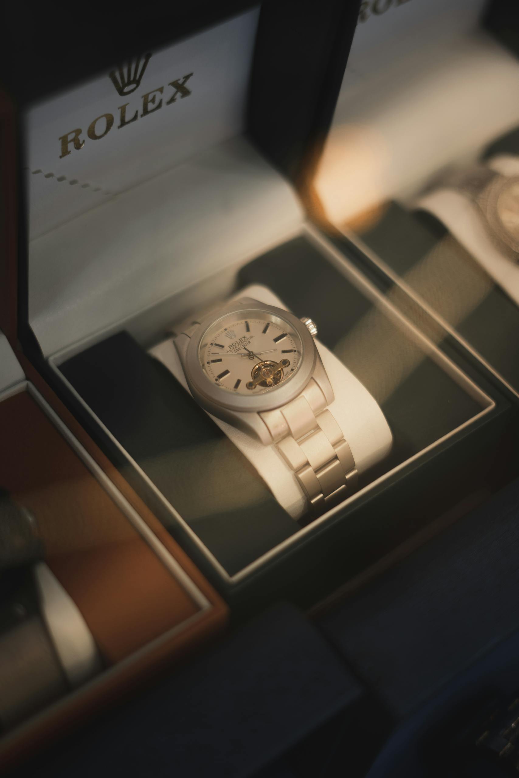 Close-up of a luxurious Rolex watch on display in a store cabinet.
