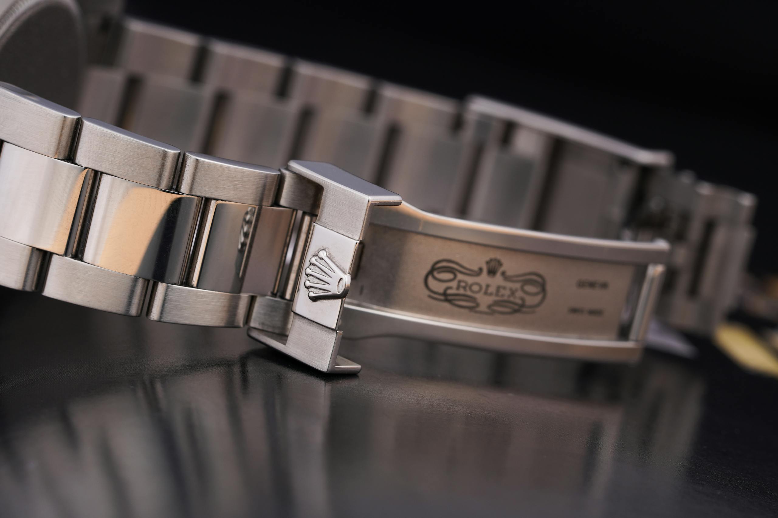 Close-up of a luxury silver watch bracelet showcasing intricate design details.